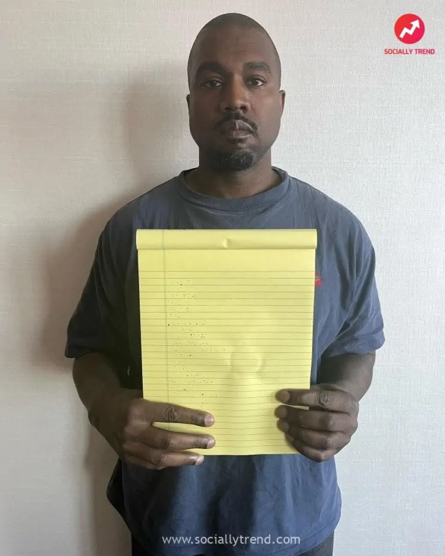 Kanye West Holding A Blank Notepad